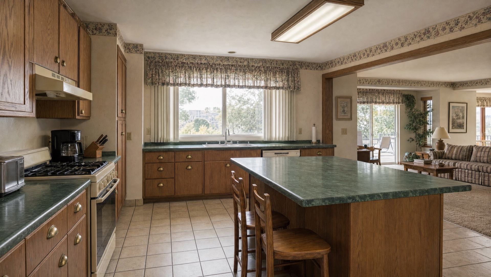 Dated 1980s Mission Trails split-level kitchen with oak laminate cabinets and Formica counters